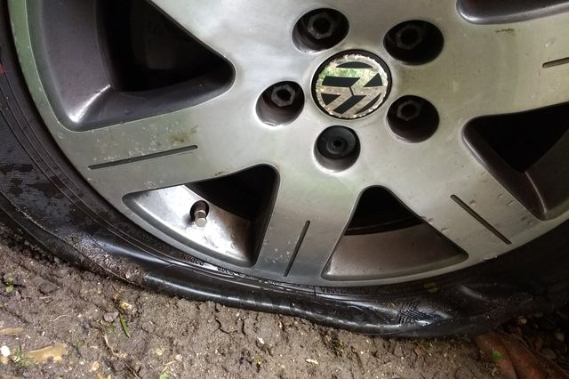A stock image of a flat tire that was slashed.
